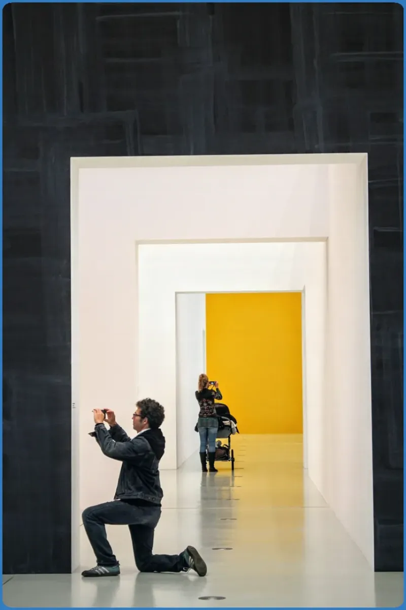 People taking photos in a modern art gallery.