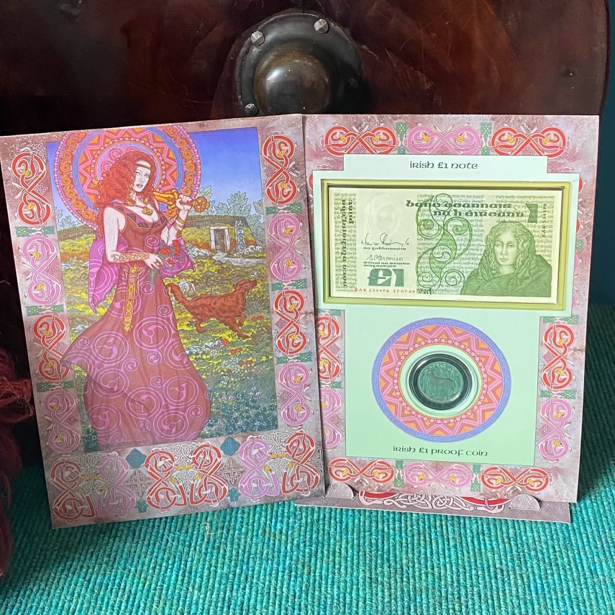 Decorative display of Irish £1 note and proof coin.